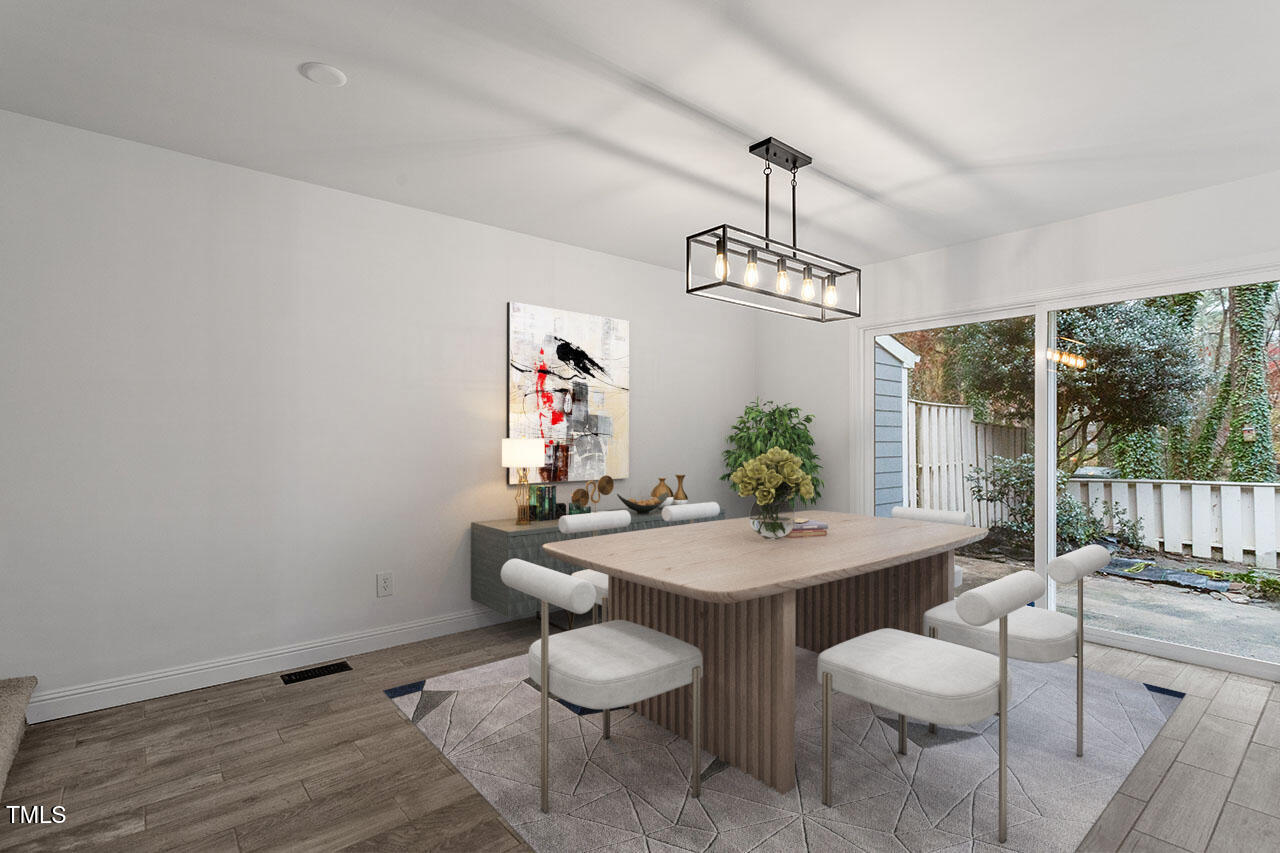1016 North Bend Drive Raleigh, NC 27609 - Photo 8 of 36 a dining room with furniture a chandelier and wooden floor