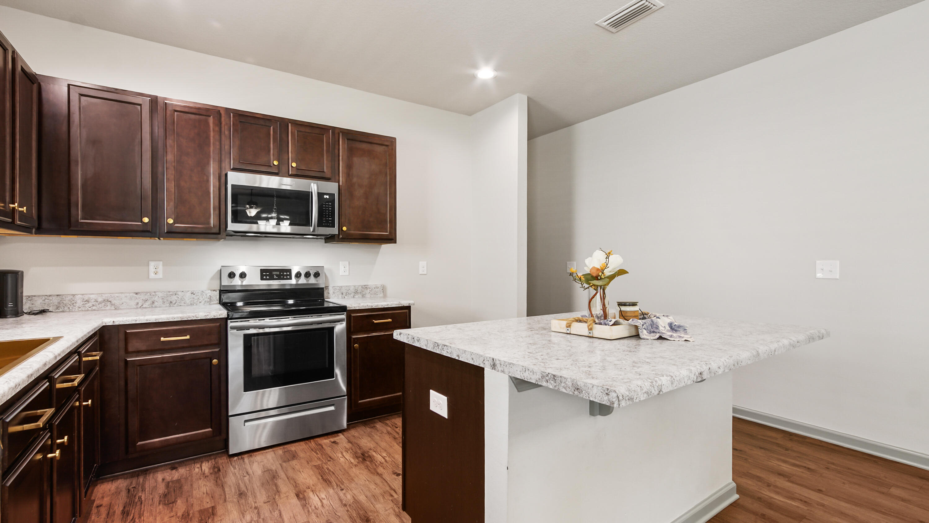 80 Sarona Street Freeport, FL 32439 - Photo 14 of 65 a kitchen with kitchen island granite countertop a sink stove and microwave