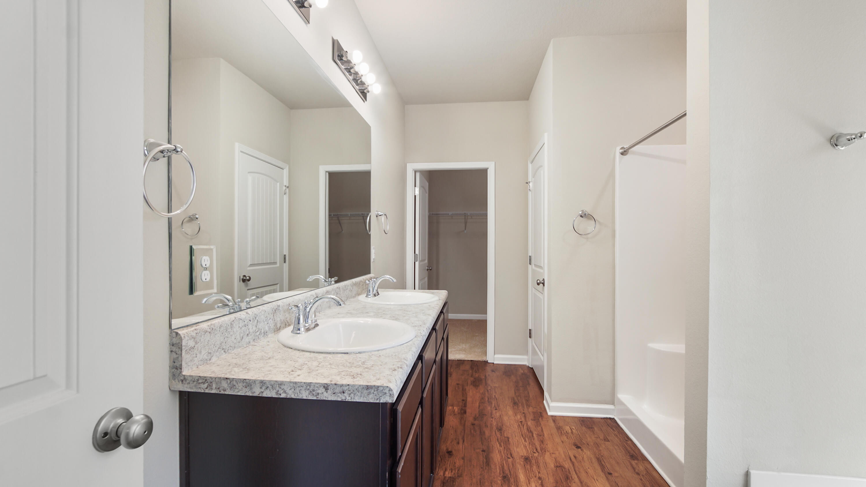 80 Sarona Street Freeport, FL 32439 - Photo 18 of 65 a bathroom with a granite countertop sink a mirror and shower