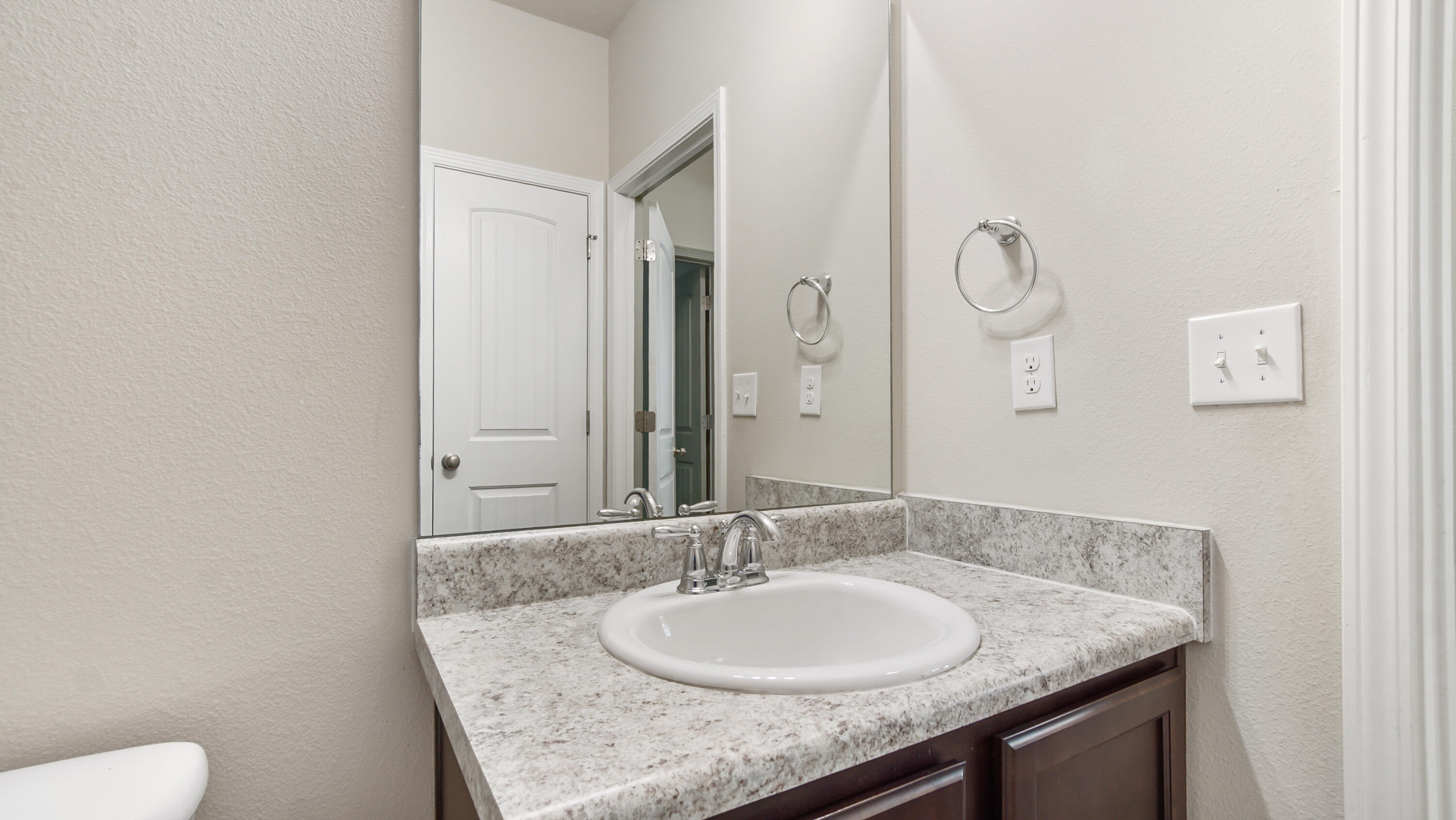 80 Sarona Street Freeport, FL 32439 - Photo 30 of 65 a bathroom with a granite countertop sink and a mirror