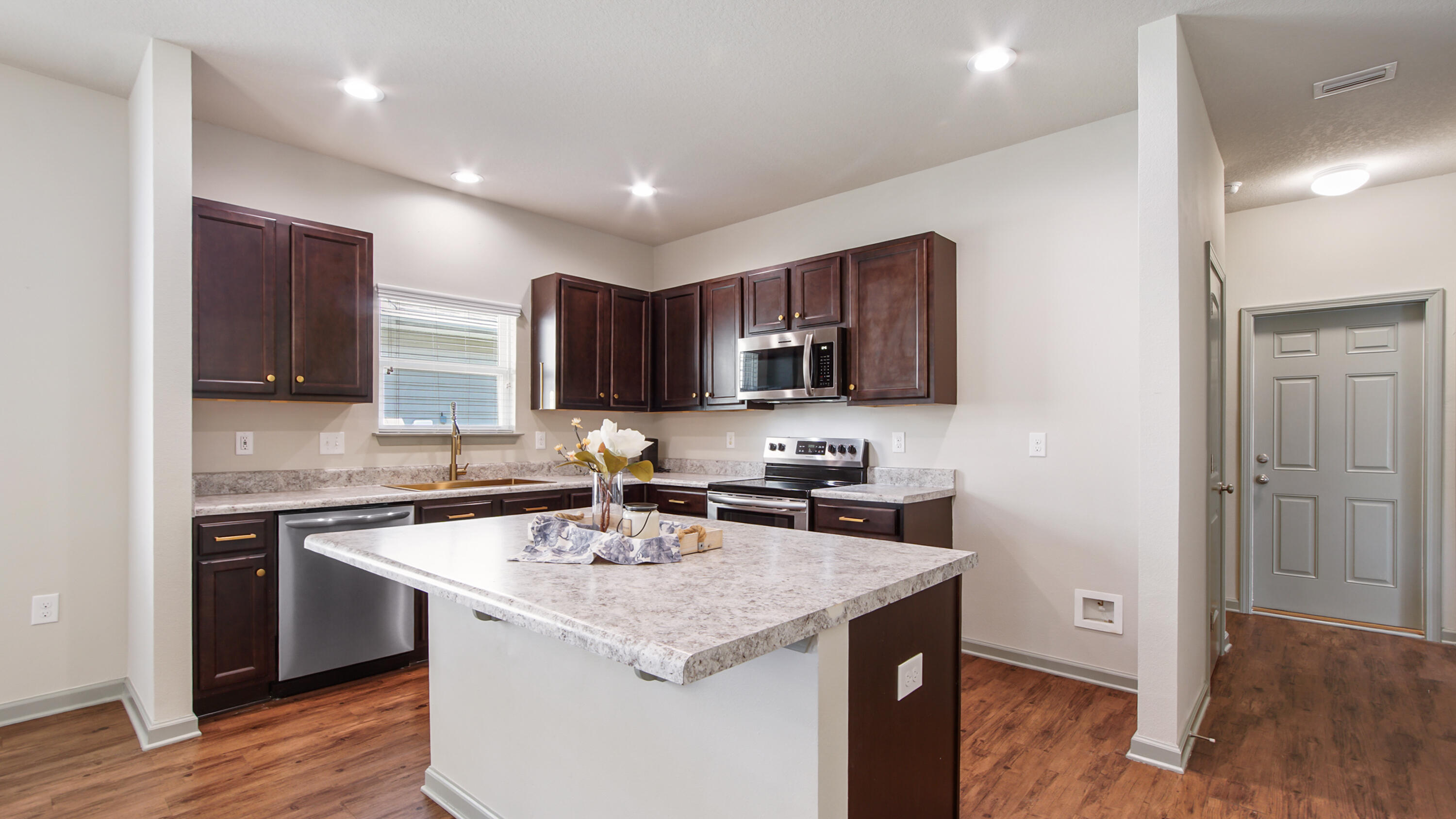 80 Sarona Street Freeport, FL 32439 - Photo 8 of 65 a kitchen with a sink stove and cabinets