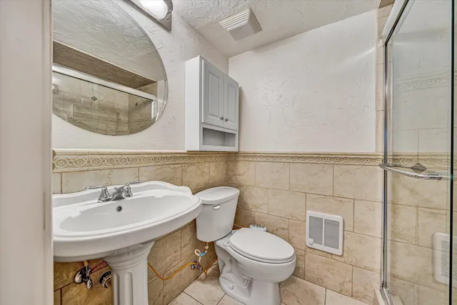 a bathroom with a toilet and a shower
