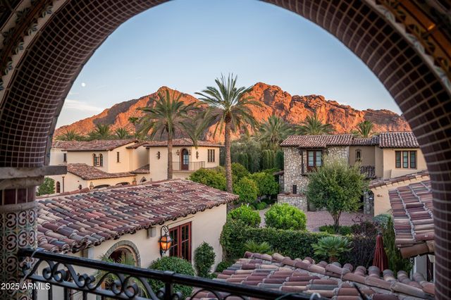 a view of a house with roof deck and next to a yard