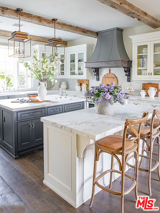 24501 Deep Well Road Hidden Hills, CA 91302 - Photo 4 of 6 a kitchen with a stove a table and chairs in it