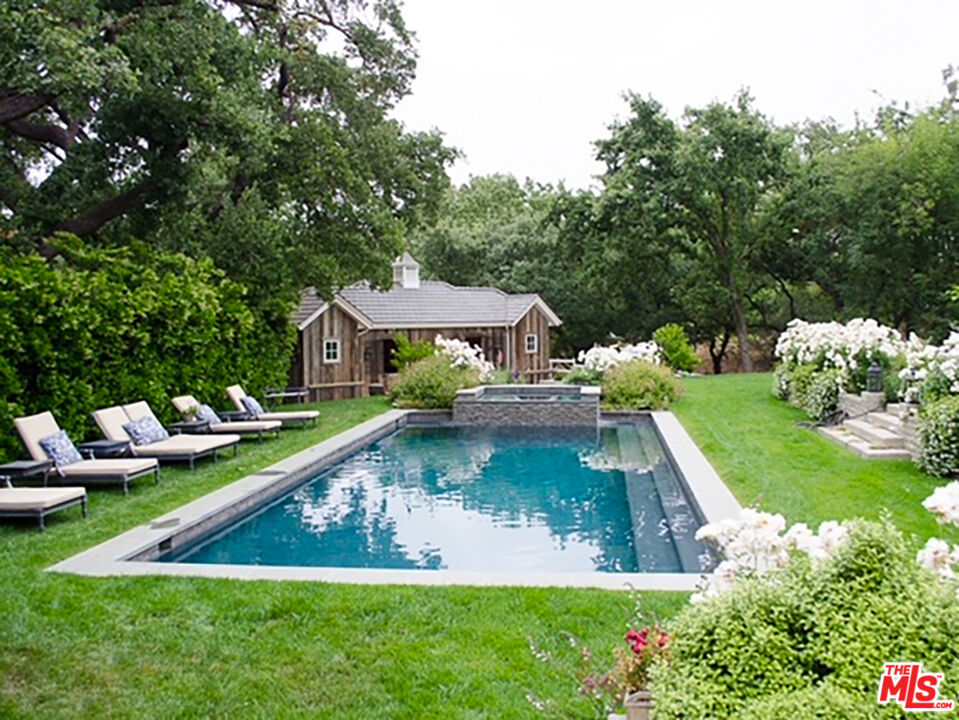 24501 Deep Well Road Hidden Hills, CA 91302 - Photo 5 of 6 a view of a house with swimming pool and sitting area