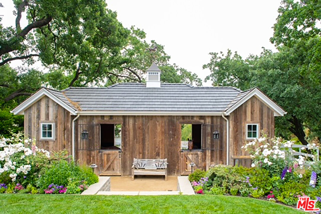 24501 Deep Well Road Hidden Hills, CA 91302 - Photo 6 of 6 a front view of a house with garden