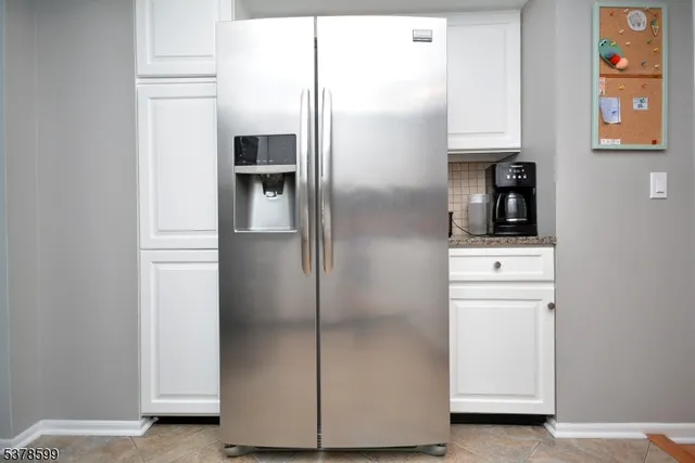 a kitchen with metallic refrigerator freezer and a dishwasher