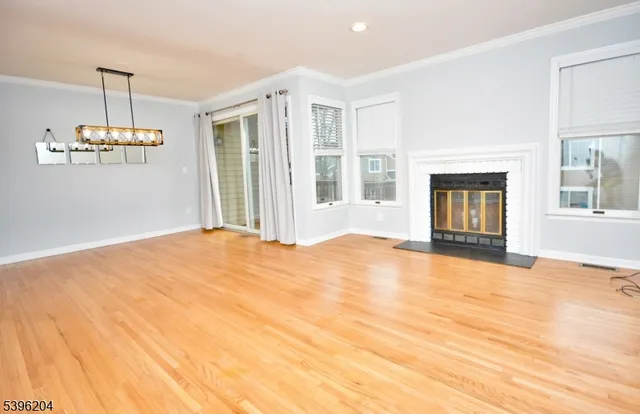 a view of empty room with a fireplace and chandelier
