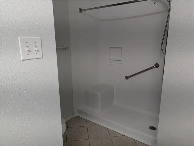 a view of backyard with wooden fence