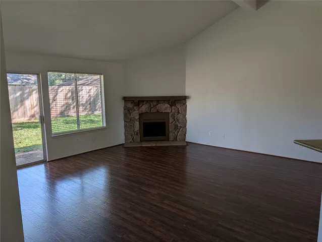 wooden floor fireplace and natural light in room