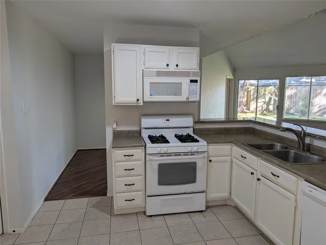 a kitchen that has a sink and a stove