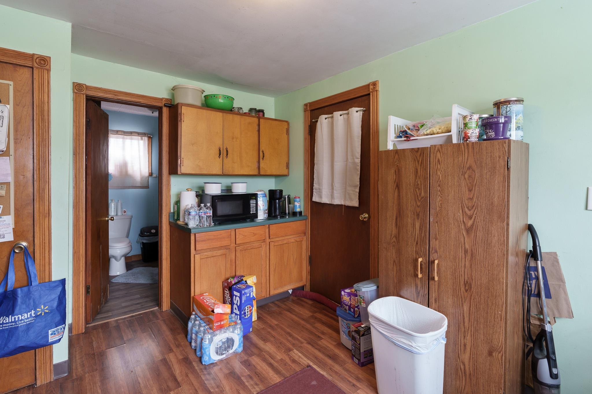 102 North Main Street Leaf River, IL 61047 - Photo 8 of 13 a kitchen with stainless steel appliances wooden floor and a refrigerator