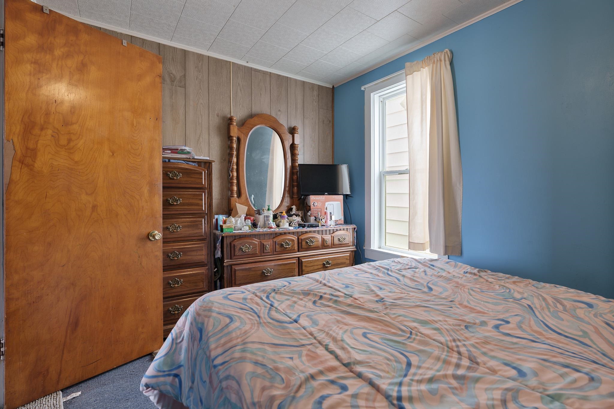 102 North Main Street Leaf River, IL 61047 - Photo 10 of 13 a bedroom with a bed and a flat screen tv