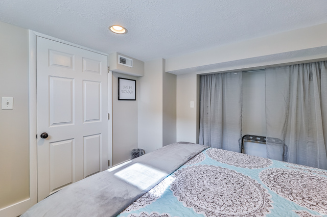 59 East 8680th Street South Sandy, UT 84070 - Photo 21 of 33 Recessed ceiling light illuminating a neutral-toned room with a white paneled door