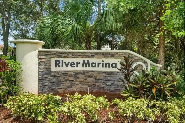 a sign that is sitting in front of flowers