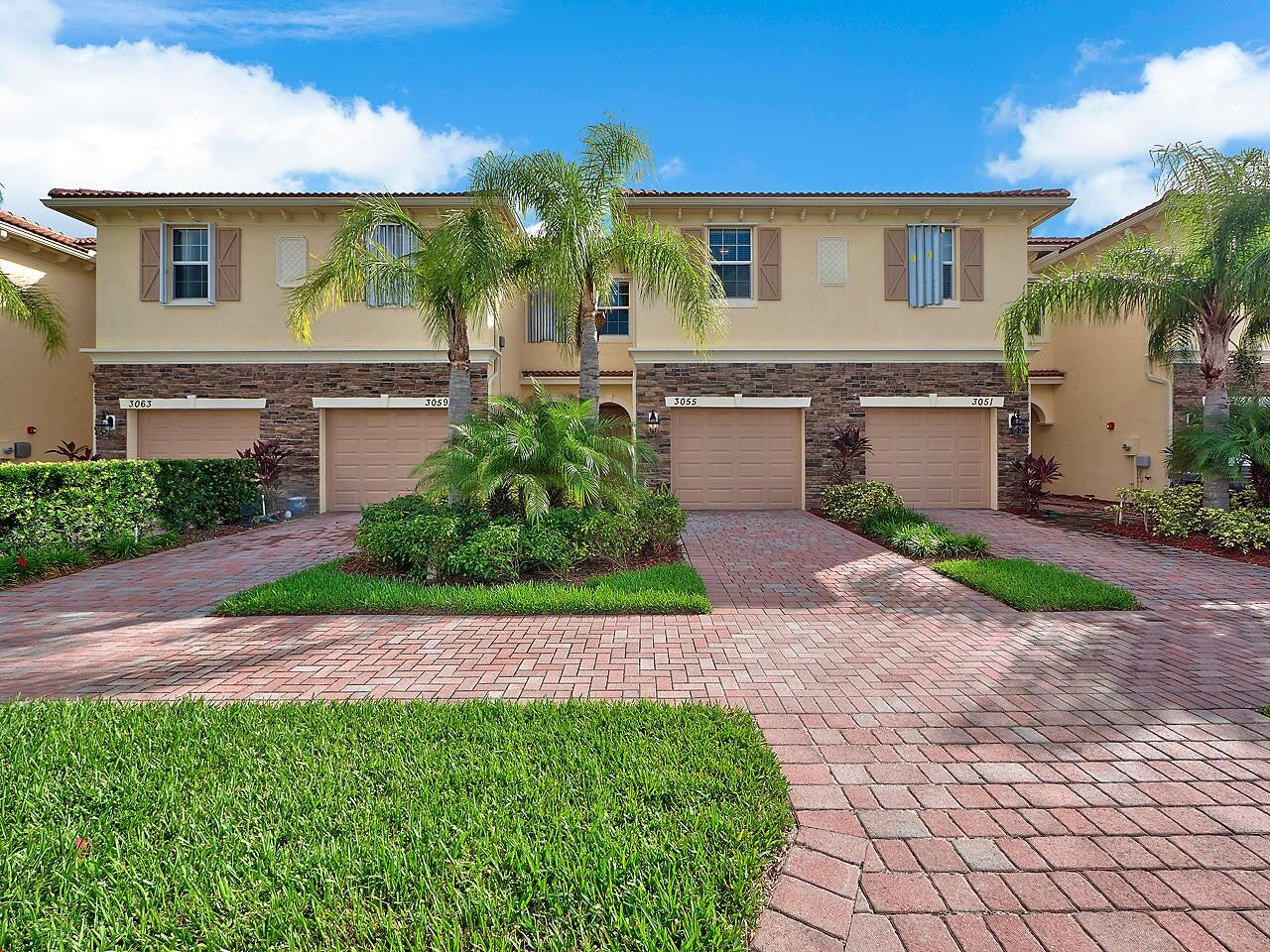 3047 Southwest Otter Lane Stuart, FL 34997 - Photo 2 of 12 a front view of a house with garden