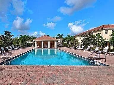 3047 Southwest Otter Lane Stuart, FL 34997 - Photo 10 of 12 a view of a house with swimming pool