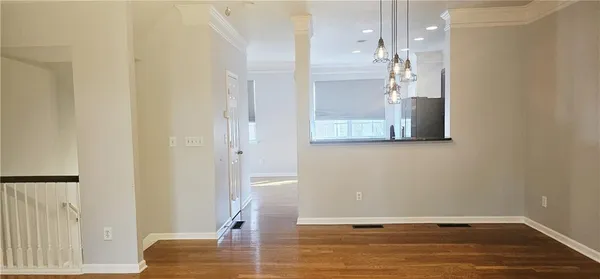 a view of a room with wooden floor and staircase