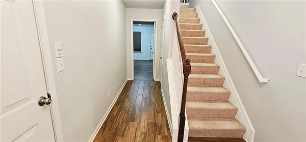 a view of staircase with white walls