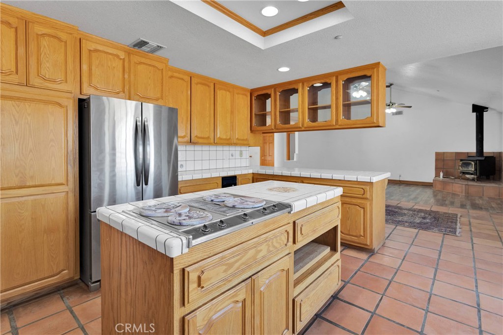 8381 White Road Phelan, CA 92371 - Photo 12 of 59 a kitchen with stainless steel appliances granite countertop a stove a sink dishwasher and a refrigerator