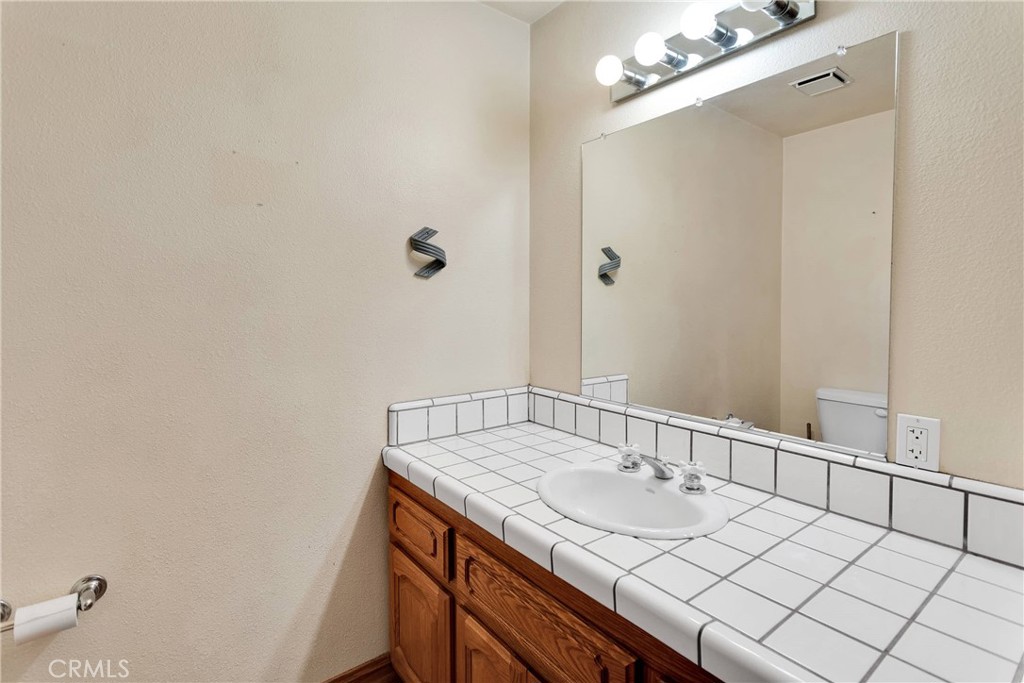 8381 White Road Phelan, CA 92371 - Photo 21 of 59 a bathroom with a sink and a mirror