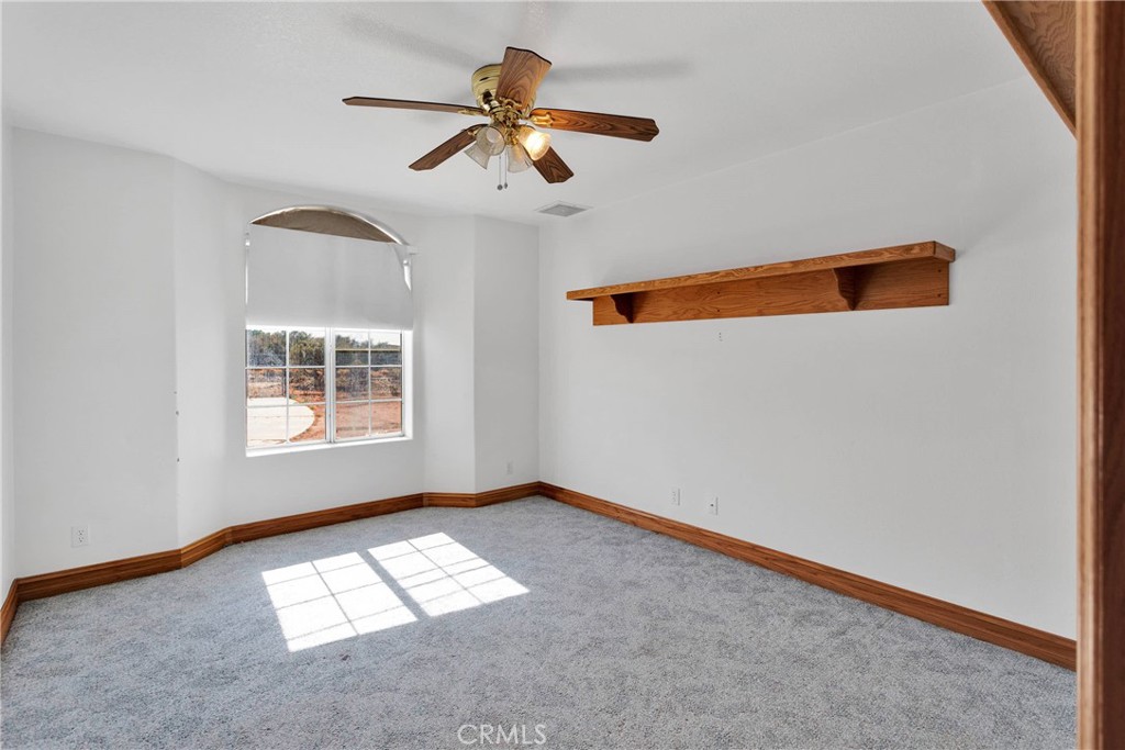 8381 White Road Phelan, CA 92371 - Photo 28 of 59 an empty room with a window and a ceiling fan