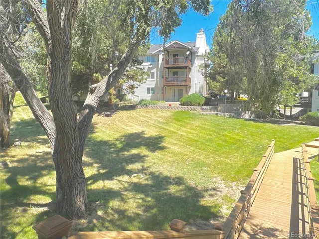 a kitchen that has a sink a stove and a refrigerator