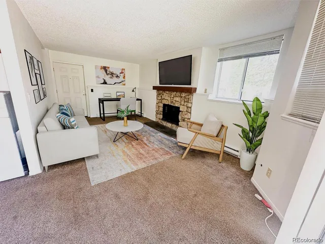 an empty room with a fireplace and cabinet