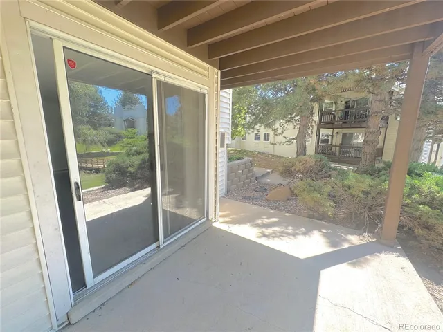 a backyard of a house with table and chairs