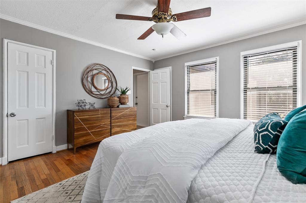 4206 Somerville Avenue Dallas, TX 75206 - Photo 11 of 26 a bedroom with a bed and a chandelier