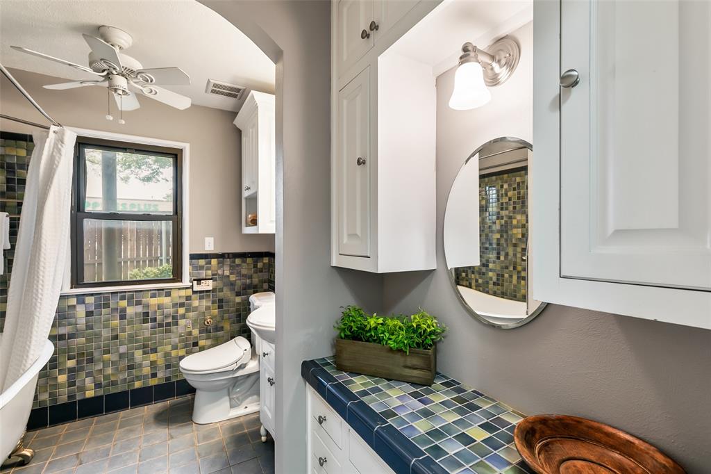 4206 Somerville Avenue Dallas, TX 75206 - Photo 12 of 26 a bathroom with a granite countertop toilet sink and mirror