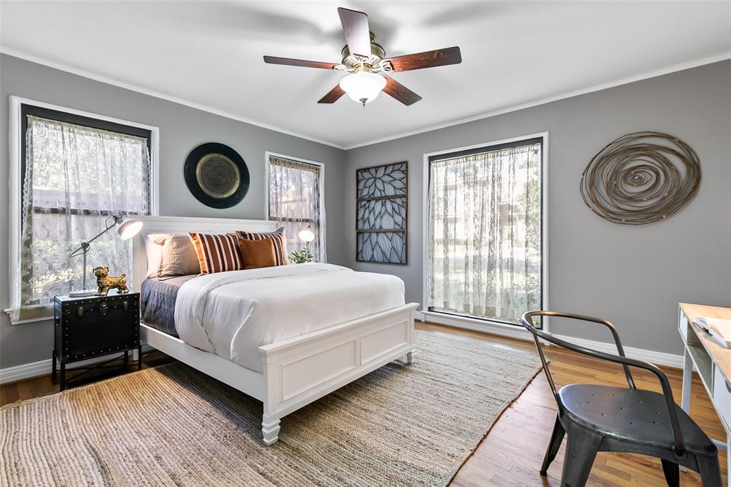 4206 Somerville Avenue Dallas, TX 75206 - Photo 13 of 26 a bedroom with a bed and a chair