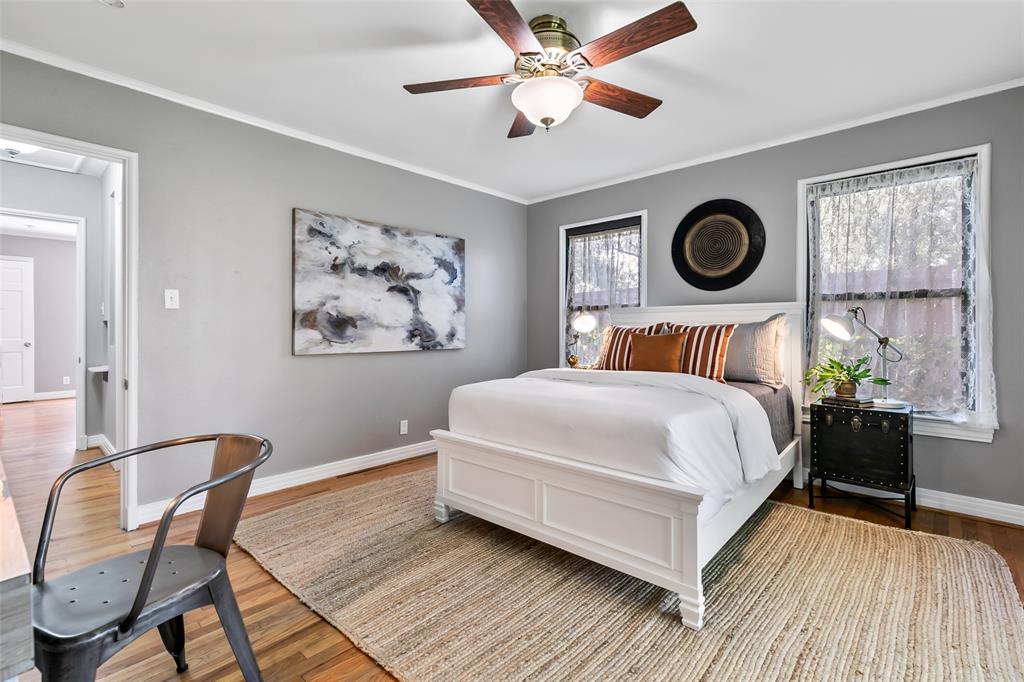 4206 Somerville Avenue Dallas, TX 75206 - Photo 14 of 26 a bedroom with a bed and dresser with wooden floor