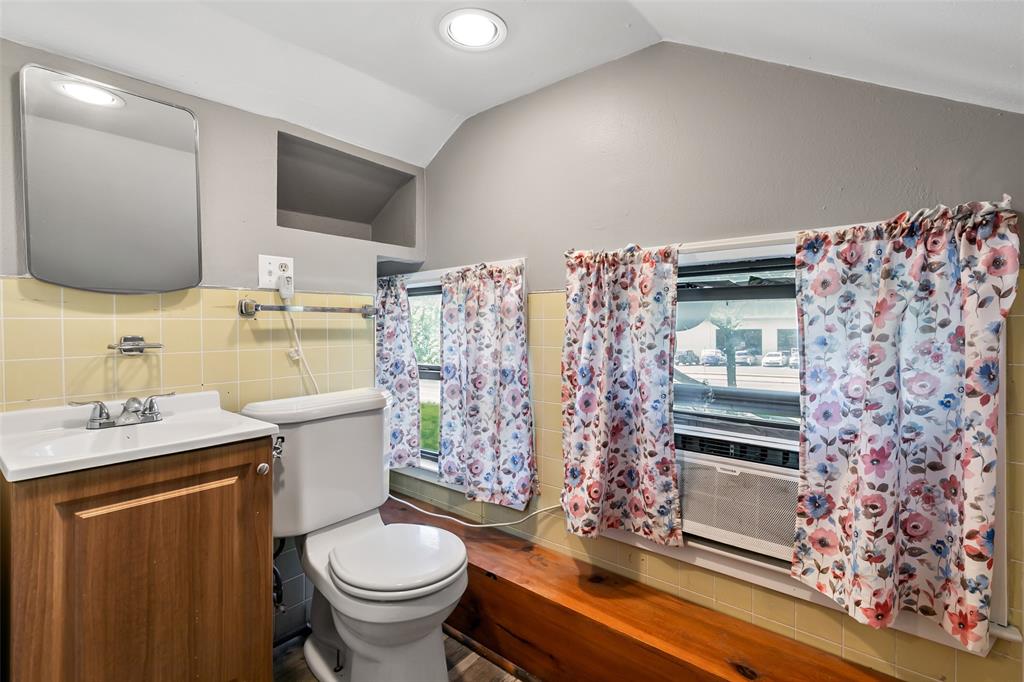 4206 Somerville Avenue Dallas, TX 75206 - Photo 17 of 26 a bathroom with a granite countertop toilet sink and mirror