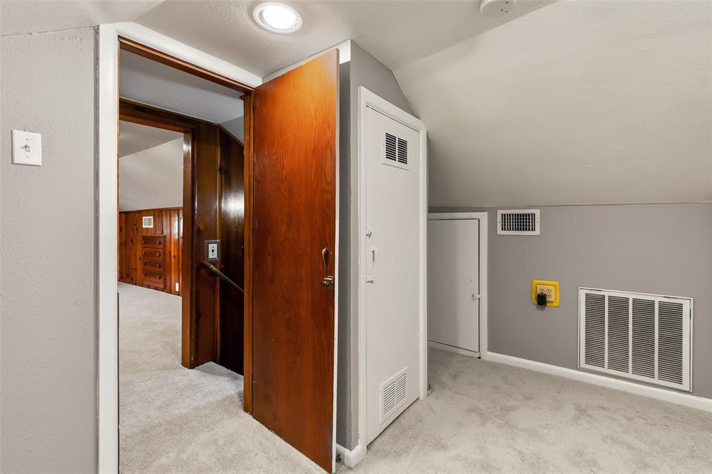 4206 Somerville Avenue Dallas, TX 75206 - Photo 19 of 26 a view of a hallway with wooden shelves
