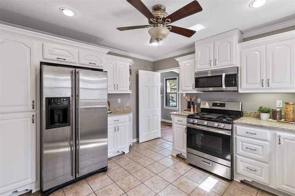 4206 Somerville Avenue Dallas, TX 75206 - Photo 7 of 26 a kitchen with stainless steel appliances granite countertop a stove a refrigerator and a sink