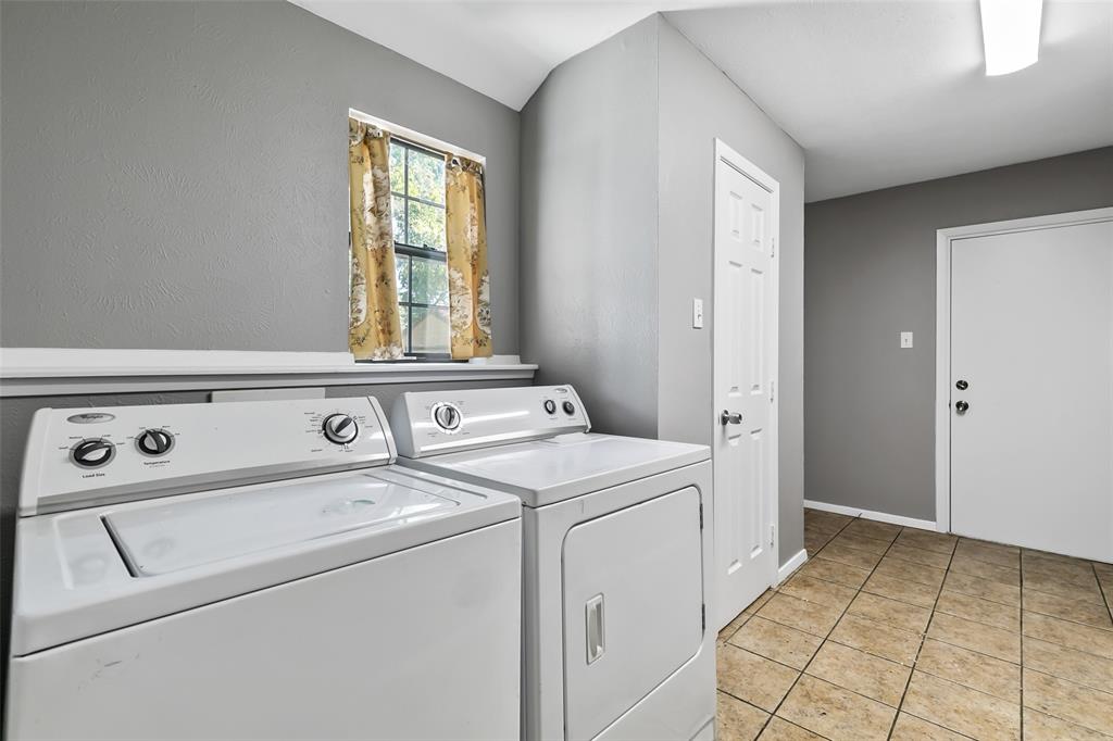 4206 Somerville Avenue Dallas, TX 75206 - Photo 9 of 26 a view of washer and dryer with bathroom in the background