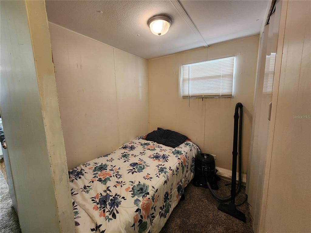 3074 Larkin Road Mims, FL 32754 - Photo 13 of 16 a bedroom with a bed and a dresser