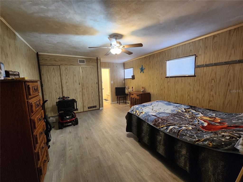 3074 Larkin Road Mims, FL 32754 - Photo 5 of 16 a bed sitting in a room next to a window