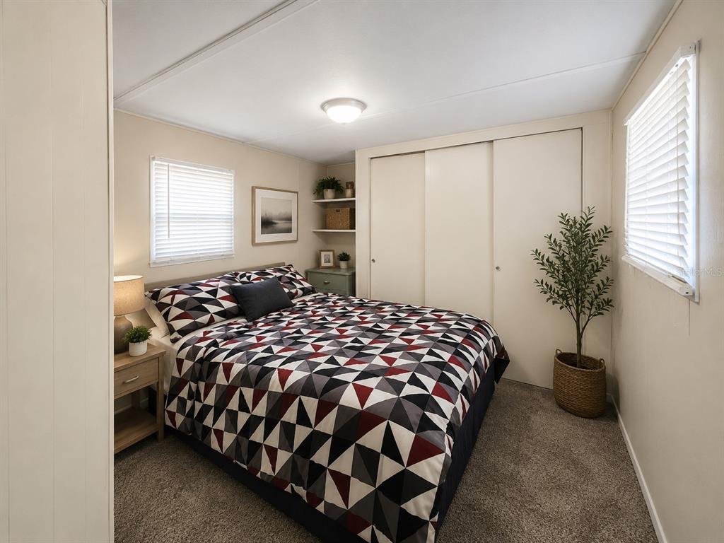 3074 Larkin Road Mims, FL 32754 - Photo 6 of 15 a bed sitting in a bedroom next to a window and potted plant