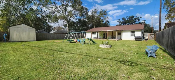 a front view of a house with yard patio and green space