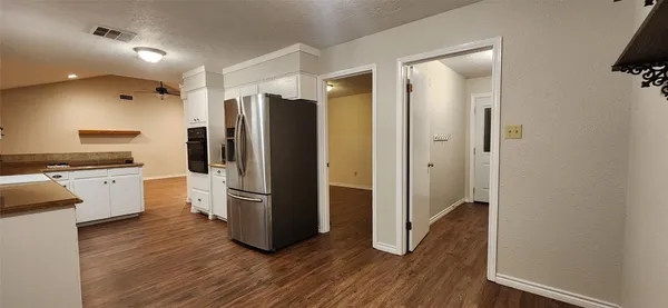 a kitchen with stainless steel appliances a refrigerator and a stove top oven