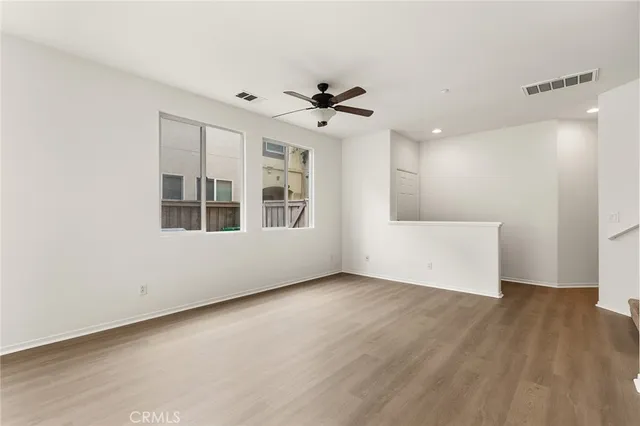a view of a livingroom with a walk in closet and wooden floor