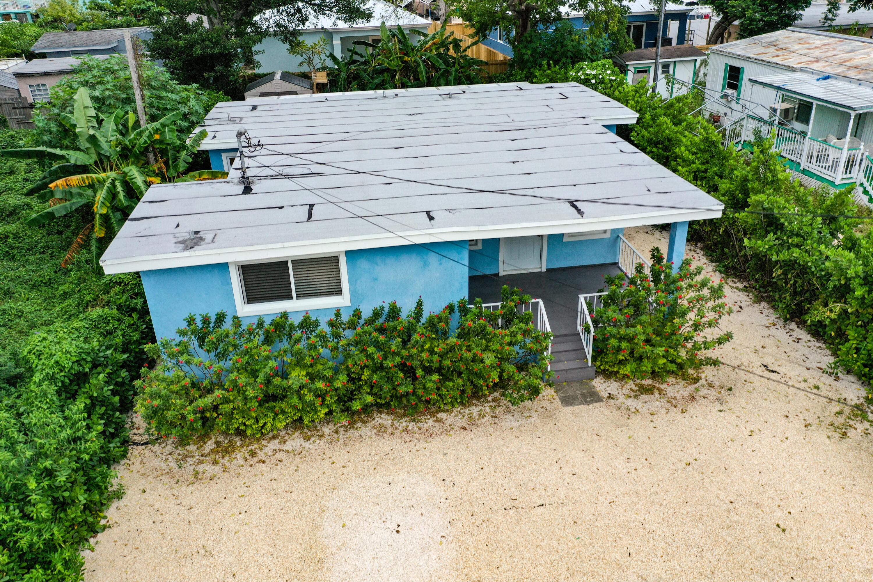 11 Judy Place Key Largo, FL 33037 - Photo 14 of 31 a view of a house with wooden walls and potted plants