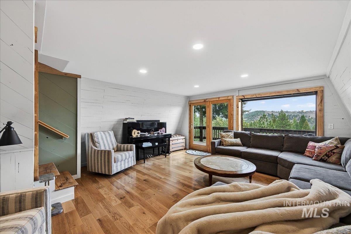 239 Tollgate Road Boise, ID 83716 - Photo 13 of 50 Living room featuring light wood-style floors, wood walls, and recessed lighting