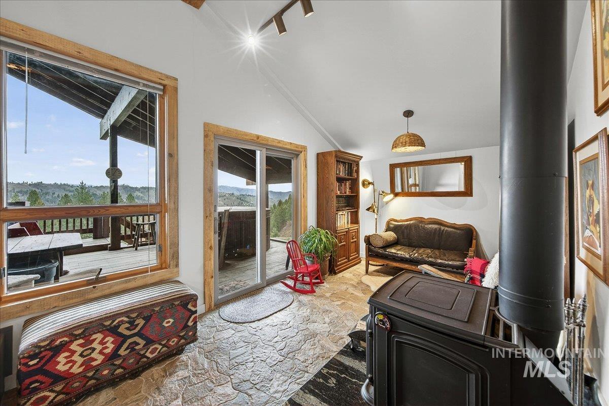 239 Tollgate Road Boise, ID 83716 - Photo 17 of 50 Living area with stone floors, plenty of natural light, and a wood stove