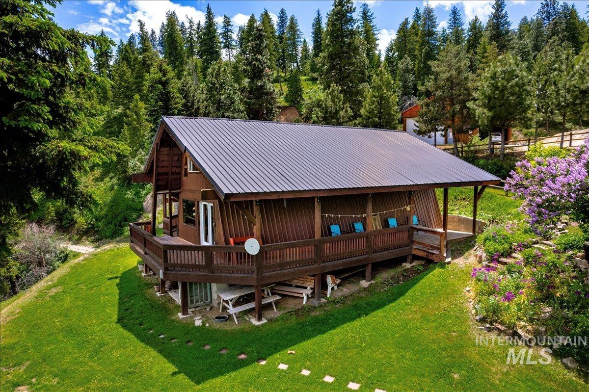 239 Tollgate Road Boise, ID 83716 - Photo 2 of 50 Back of house featuring a metal roof, a lawn, and a porch