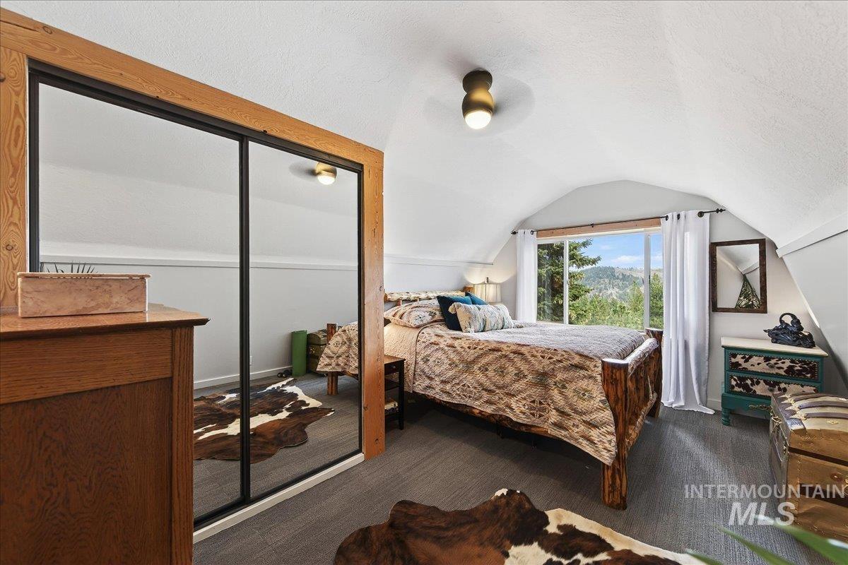 239 Tollgate Road Boise, ID 83716 - Photo 26 of 50 Bedroom featuring a ceiling fan, a closet, dark carpet, and a textured ceiling