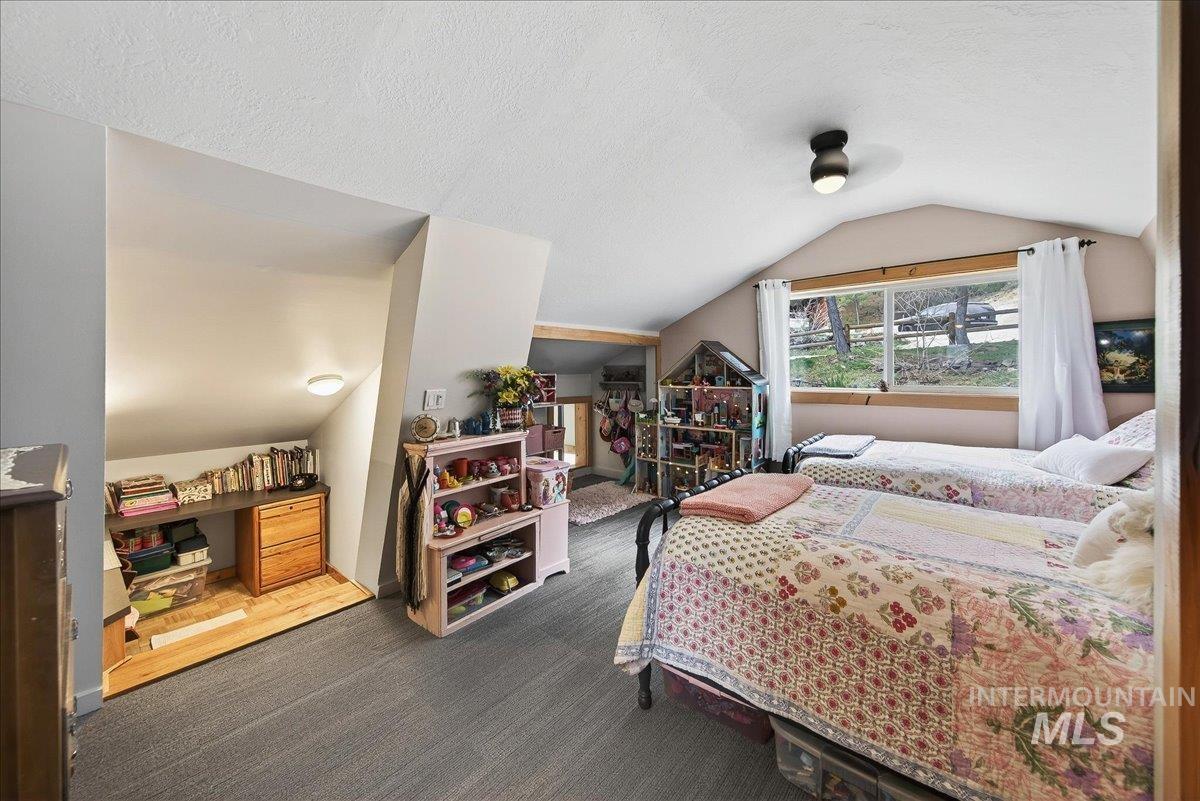 239 Tollgate Road Boise, ID 83716 - Photo 29 of 50 Bedroom with dark carpet, a textured ceiling, and a ceiling fan