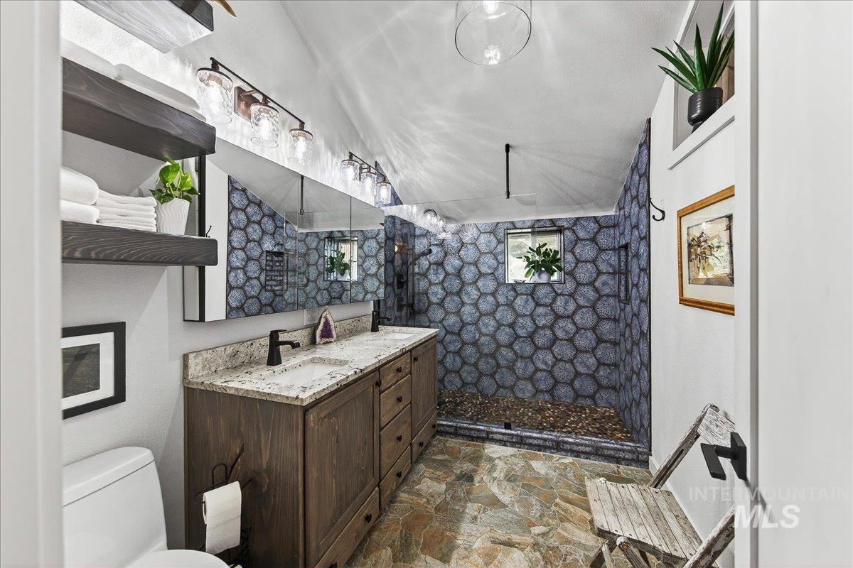 239 Tollgate Road Boise, ID 83716 - Photo 9 of 50 Bathroom with walk in shower, vanity, and stone flooring